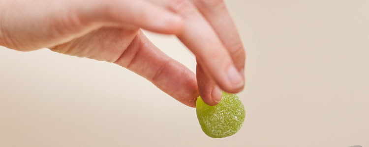 hand holding cannabis edible gummy